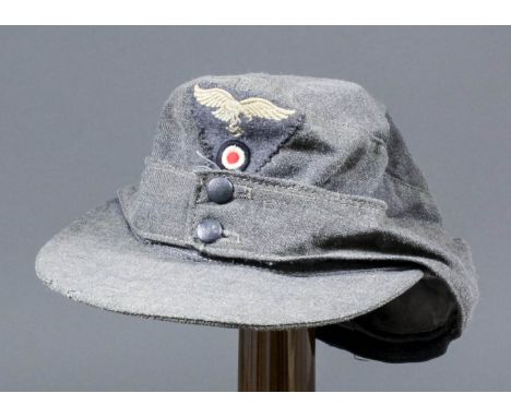 A German World War II  Luftwaffe soft stiffened visor two-button cap, the inside with printed label dated "1944"