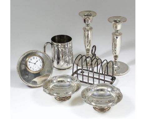 A pair of Elizabeth II silver pillar candlesticks with urn pattern sconces, plain stems and on circular footrims, 6.625ins hi