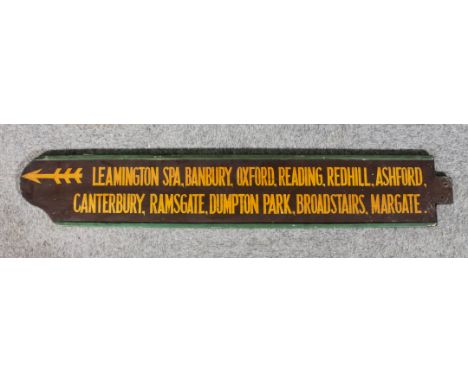 A railway station wooden finger board - "Leamington Spa ... Margate", on two lines with pointing feathered arrow, double side