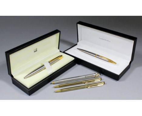 Two Alfred Dunhill AD2000 ballpoint pens in brushed steel and gilt metal casing and boxes for same, complete with original ce