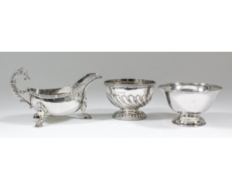 An Elizabeth II silver oval sauce boat with embossed Celtic pattern rim and high scroll handle, on three lion mask scroll pat