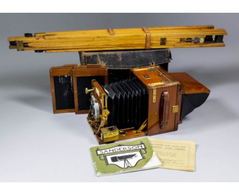 An early 20th Century "Sanderson" mahogany and brass half plate camera in leather case, with instruction manuals and oak exte