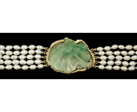 A modern five strand freshwater pearl necklace, 720mm overall, with integral 14k gold and jadeite oval pattern pendant, 60mm 