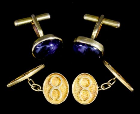 A pair of modern gentleman's 18ct gold oval pattern cufflink's, the textured face with hieroglyph, 17mm x 15mm overall, with 