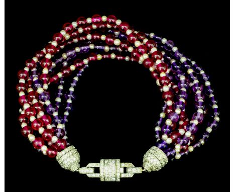 A 1920s platinum mounted rubellite, amethyst and seed pearl eight strand bracelet, the tassel pattern clasp pave set with ros