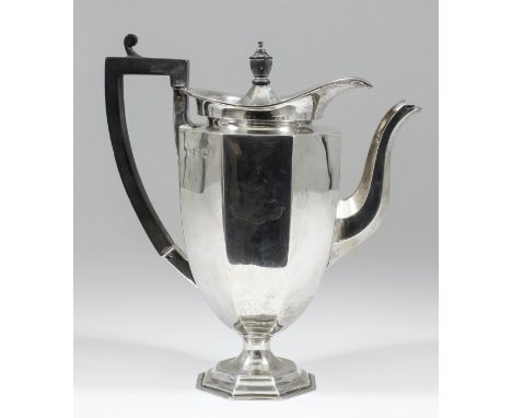A George V silver coffee pot of octagonal panelled form, with ebonised finial and angular loop handle, 9.5ins high, by Dobson