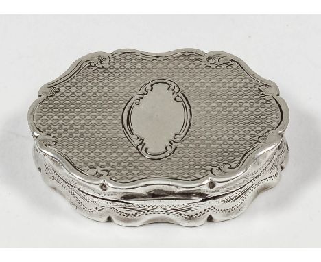 A Victorian silver oval vinaigrette of scroll outline, with engine turned ornament and the lid with oval cartouche, the gilt 