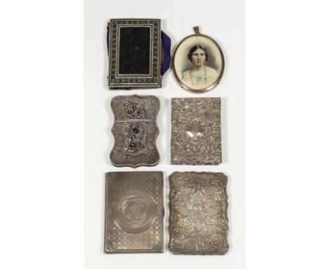 A late Victorian silver rectangular card case of shaped outline engraved with central flower, all over floral and scroll orna