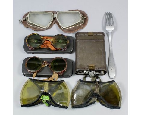 Two pairs of German World War II desert sand goggles, a pair of Aviators goggles, two pairs of green tinted goggles in tins, 