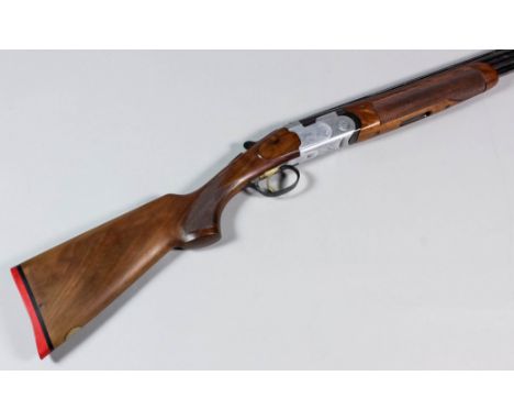 A 20 bore over and under shotgun by Beretta, serial No. E89297B,  28ins blued steel barrels with raised top rib, plain action