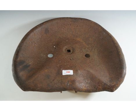 A cast-iron tractor seat