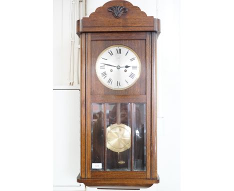 A 1930s oak wall clock
