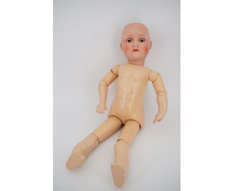 A Heinrich Handwerck of Germany bisque-headed doll, having fixed brown glass eyes, an open mouth and jointed composition body