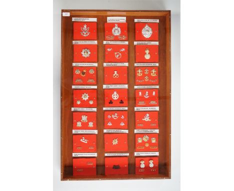 A large framed display of late 20th Century British army badges