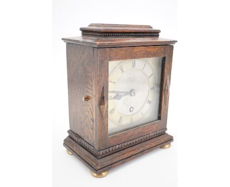 A 1920s small oak-cased mantel clock retailed by Russells of Liverpool, 19.5 cm