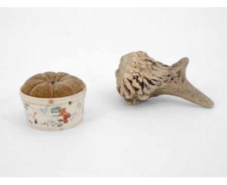 An early 19th Century turned bone pin cushion together with an antler tool