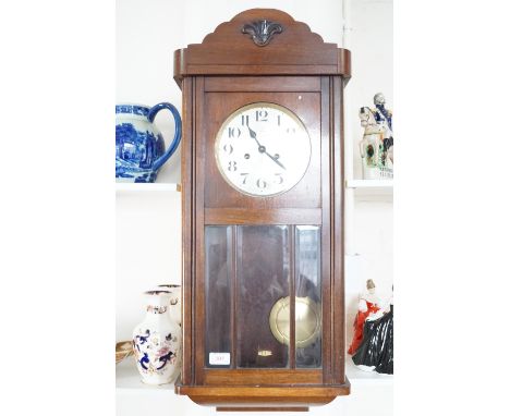 An oak wall clock 78cm