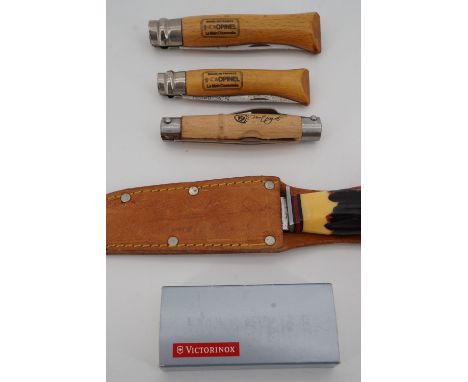 An Icel sporting knife with saw-backed Bowie type blade, two French Opinel folding lock knives, one other clasp knife and a S
