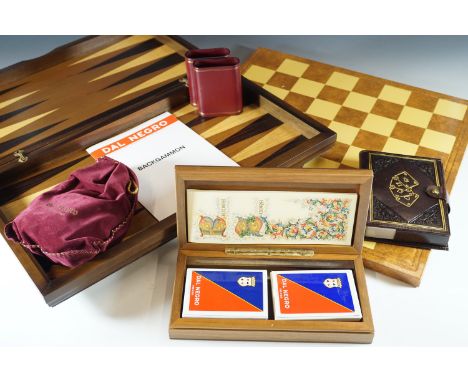 A backgammon set, boxed playing cards, chess board etc