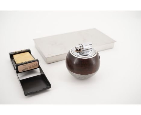 A Danish stainless steel table cigarette box, together with a brass Zippo lighter, model No 204, and a novelty table lighter 