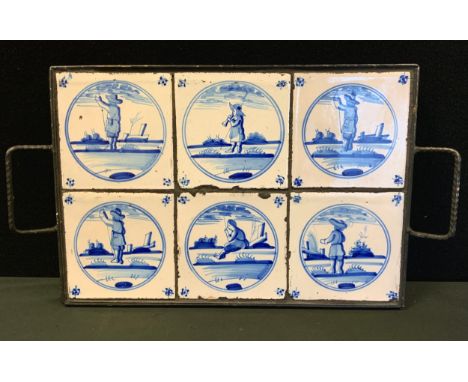 A set of six 18th century style Dutch Delft tiles, mounted in a later metal tray, each tile measuring 13cm x 13cm. 