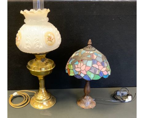 A Tiffany style leaded glass table lamp, the shade with dragonflies amongst lilies 37cm tall;  a brass electric lamp in the f