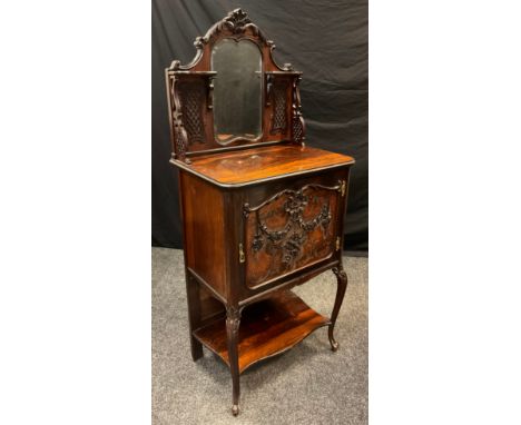 An Edwardian Rosewood music cabinet, galleried back with carved cresting above a small, shaped looking glass, fretwork bracke