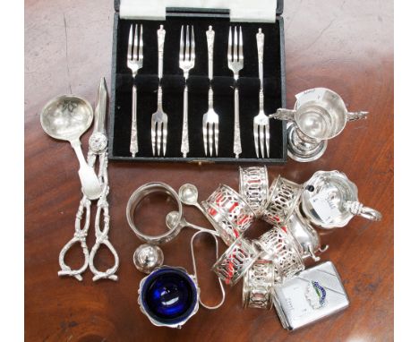 A collection of silver plated items to include a boxed fork set, cruet and grape shears, vesta case and napkin rings.