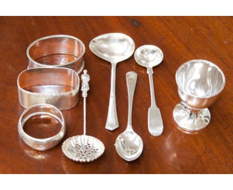 A silver group to include napkin rings, spoons and egg cup.