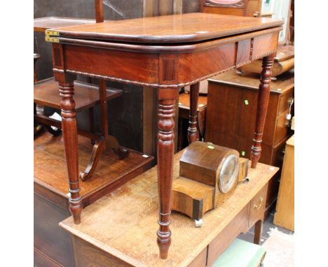 A George IV mahogany tea table, the top folding out, raised on baluster and ring turned legs