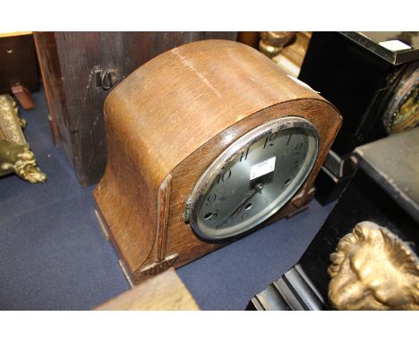 An Art Nouveau style wooden mantle clock.
