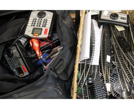 A wicker basket of 00 scale railway track, spares and a holdall of Hornby digital controller and tools 