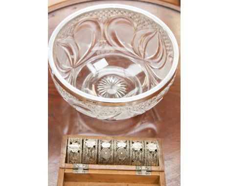 A matched set of six silver filigree napkin rings and a glass fruit bowl (s.d. to base) with a Walker & Hall silver rim, Shef