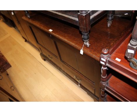 A George III oak mule chest, the lidded section opening to reveal large storage area, fitted with two drawers to base, raised