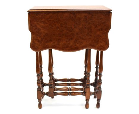 An early 20th Century burr veneered ladies gateleg table, raised on baluster and ring turned legs, united by matching stretch