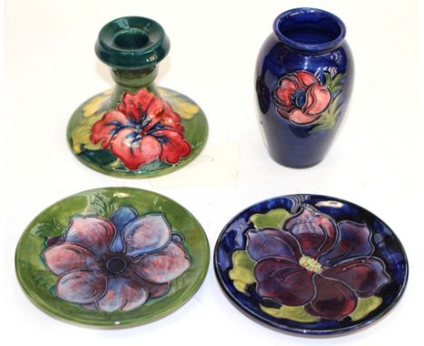 A collection of Moorcroft, comprising blue vase, two pin dishes and a small candlestick, all early and mid 20th Century. (4)