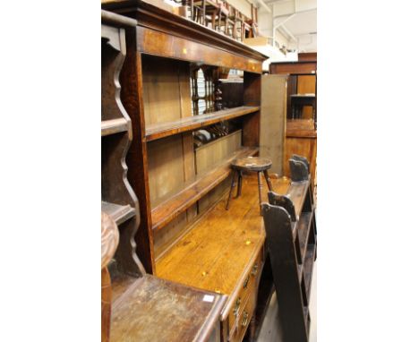 A George III oak dresser and rack, the rack with two plate shelves, the base section with three drawers over two drawers abov