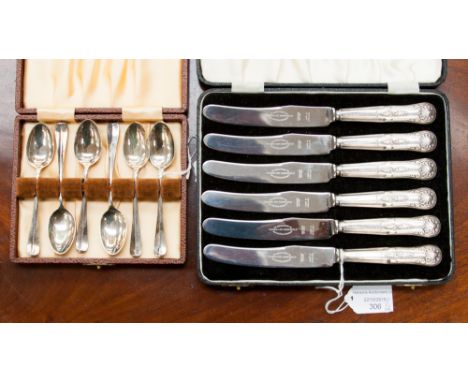 A boxed set of six silver teaspoons, Sheffield 1955, 58.6 grams/1.88 ozt, together with a set of six butter knives, boxed. (2