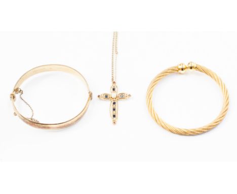 A 9ct gold cross set with sapphire, diamonds, rubies and synthetic pearl, a 9ct bangle - metal cone and amulet style bangle (