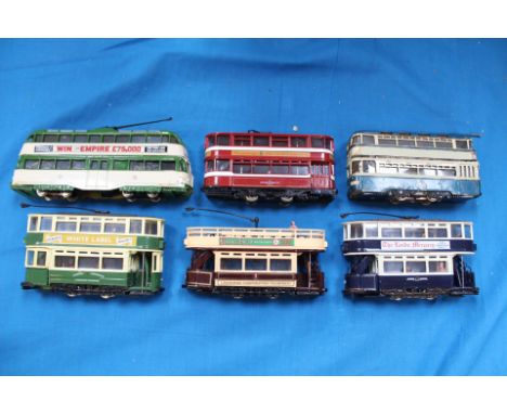A group of six trams by Corgi, EFE and Kitbuilt, motorised using Bachmann, Tenshodo, etc units, running on 00 gauge track