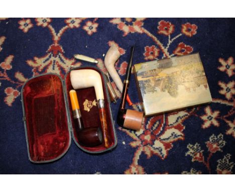 Four pipes, two with sterling silver mounts and a wooden box with contents to include corkscrews, cigar cutters and pen knive