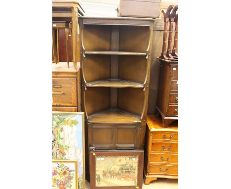 An Ercol solid elm corner cupboard, fitted with two shelves to upper section, with a single panelled door to base