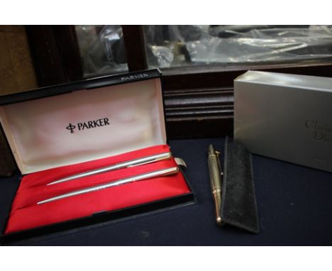 A Christian Dior fountain pen, 14 carat gold nib, cased, with guarantee card and sleeve with other pens.