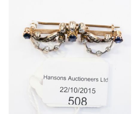  A Victorian sapphire and diamond knife edge brooch claw set, oval sapphire to the centre and round sapphires to each termina