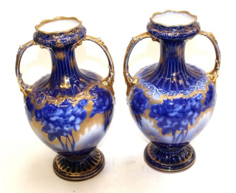 A pair of late 19th Century ceramic vases with gilt highlights.