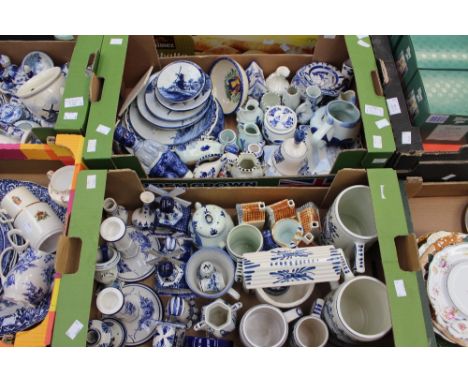 Three boxes of assorted blue and white Delftware, comprising figures, plates, dishes, novelty windmills, bowls, mugs, candles