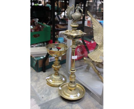 A brass Gothic style table ashtray, together with a Gothic style pedestal candlestick. (2)