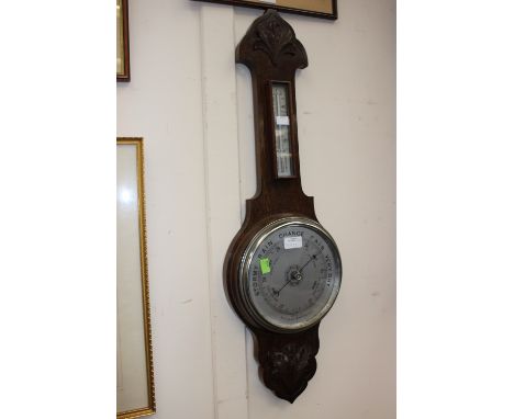An early 20th Century oak barometer and thermometer.