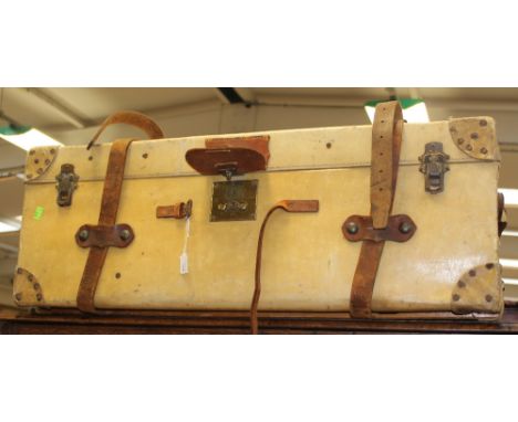 A 1920's travel trunk, cow hide with straps.