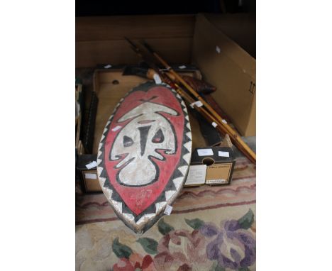 A stone blade axe, three fishing spears South American and a shield.